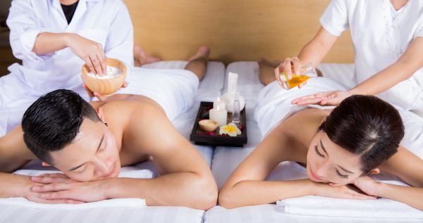 a photo of two people getting a couple massage.