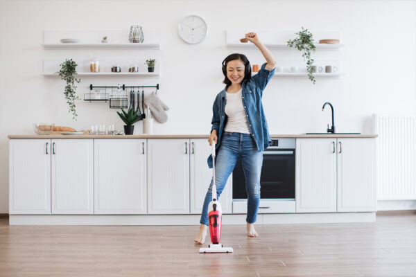 person happily cleaning her living room