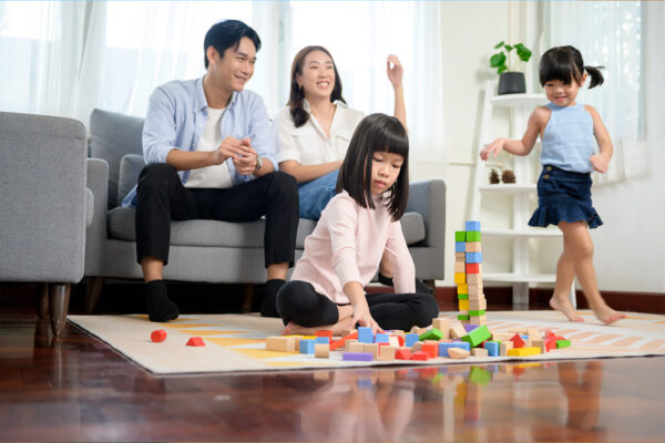 family in the living room with kids playing