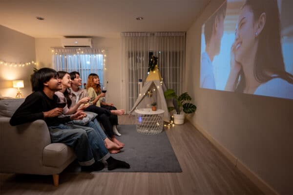 group of friends watching a movie at home