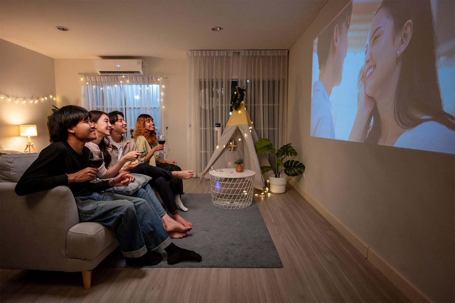 group of friends watching a movie at home